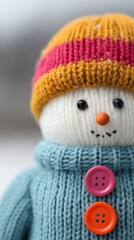 Snowman with colorful buttons and knitted hat