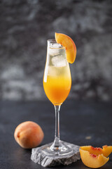 Summer alcohol drink peach bellini or mimosa in flute glasses. Brunch cocktail