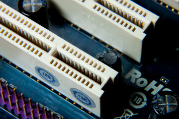 Close-up of an assembled electronic printed circuit board with slots and connectors