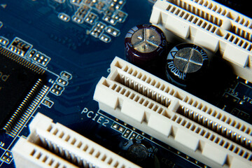 Close-up of an assembled electronic printed circuit board with slots and connectors