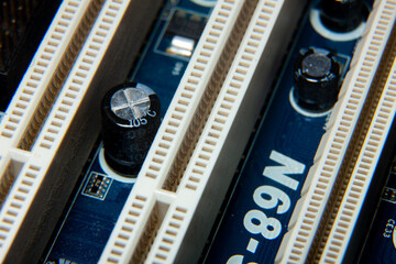 Close-up of an assembled electronic printed circuit board with slots and connectors