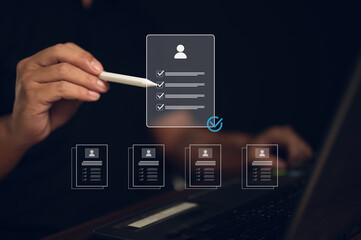 HR and recruitment concept. A manager uses a digital pen to review a resume, CV, or online application. Checking candidate qualifications on a list for job hiring and business process approval.