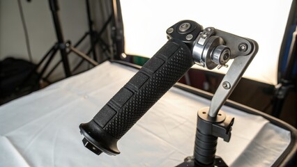 Close up of camera stabilizer handle with focus on grip and mechanics