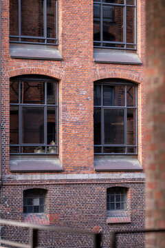 Red brick facade detail in Speicherstadt Hamburg with repetitive windows and architectural geometry