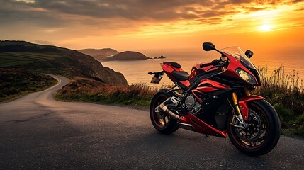 Fototapeta premium Motorcycle on a quiet coastal road during golden hour with the sea sparkling
