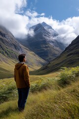 Fototapeta premium Young asian female adventurer exploring majestic mountain landscape with snow-capped peaks
