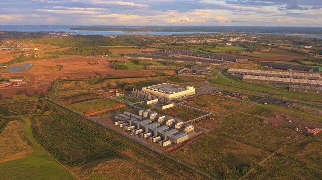 Sunset aerial footage of a massive Google data complex with fiber network connections, digital storage, and global cloud computing backbone.