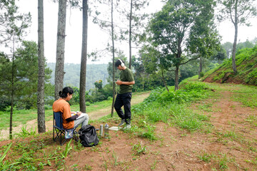 Two Young Men Embracing Nature's Beauty During Creative Outdoor Sketching Session