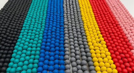 Rainbow Sphere Grid
Rows of matte colored balls aligned in a spectrum, from black to pink, like organized confetti.