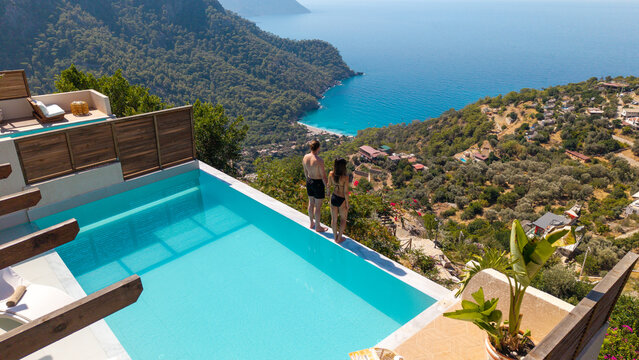 Romantic getaway concept with a couple relaxing together above the blue sea