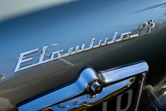 Close up of vintage Lancia Flaminia brand logo on old car in exhibition during a vintage car rally in Varallo Sesia, Italy, September 29, 2025