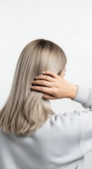 Woman with ash blonde hair touching head isolated on white background