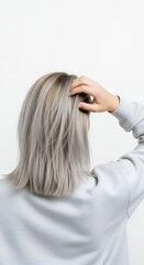 Woman with grey hair and hand on head against white background