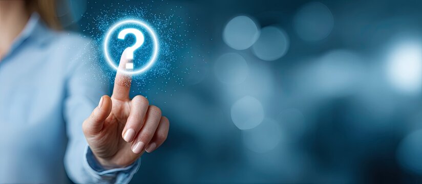 A person?s hand touching a glowing question mark on a blurry blue background