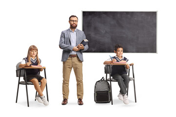 Teacher holding books and posing in a classroom with pupils