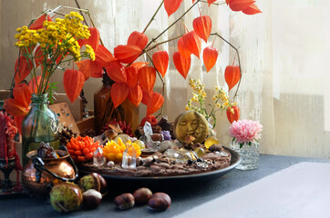 wiccan altar, witch place with magic things, amulets, minerals, flowers on table close up. Witchcraft, magic Ritual. spiritual esoteric practice for meditation, relax.