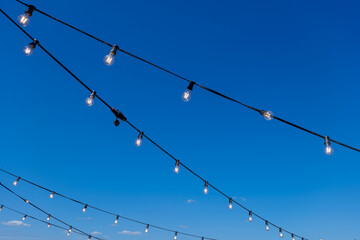 A garland of lights against a blue sky background.