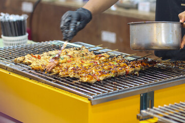 Grilling Chicken Skewers at Asian Street Food Market