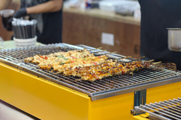 Grilled Chicken Skewers on BBQ at a Street Food Market