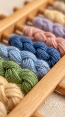 Colorful strands of embroidery floss arranged neatly on a wooden holder, perfect for crafting projects.