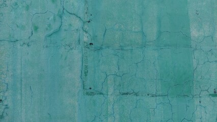 Cracked turquoise wall texture, perfect for grunge, vintage, or urban-themed designs. The detailed cracks and color give depth and realism for creative projects.