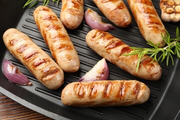Pan with grilled sausages and spices, top view
