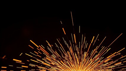 Bright orange sparks fly dynamically against a dark backdrop, evoking industrial metalwork energy.