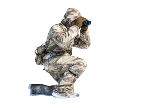 Trekker in camouflage gear scouting with binoculars in snowy terrain, ready for adventure