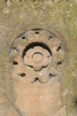 Eroded Carved Circular Pattern in Old Stone Gate Post in Close Up 