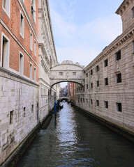 Scenic view of stone bridge and canal with old buildings in Venice Italy