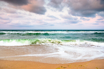 dramatic beach outdoor background. scenic coast and sky with clouds. beautiful seascape. wave bring foam on golden sand