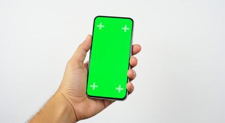 Confident hand holding modern smartphone with vibrant green screen for creative editing and content integration