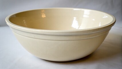 Glossy cream colored ceramic bowl perfect for cooking and serving