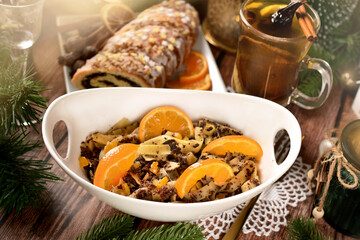 Traditional Christmas Eve desserts with poppy seed noodles and rolled cake