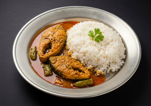 Classic Bengali Pabda Fish Curry with Steamed White Rice, a Spiced Freshwater Delicacy, Perfect for Traditional Indian Meals