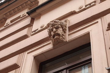 Statue of a man with a beard and a beard is on the wall