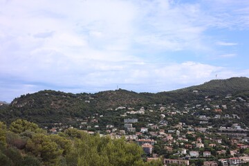 Picturesque view of city with buildings and trees in mountains
