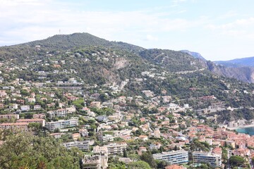 Picturesque view of city with buildings and trees in mountains