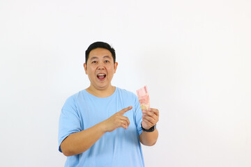 Excited man holding Indonesian Rupiah banknotes