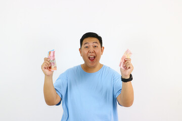 Portrait of happy young asian guy Offering Money