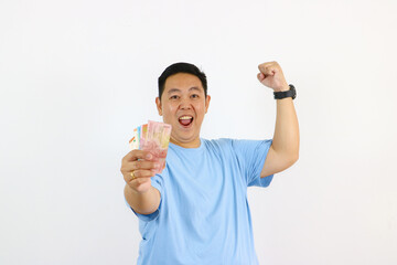 portrait young sian guy holding Indonesian Rupiah Bank note on isolated white background