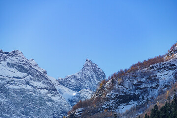 Picturesque landscape in Dombay with amazing snow-capped peaks and majestic blue slopes of North  Caucasus Mountains