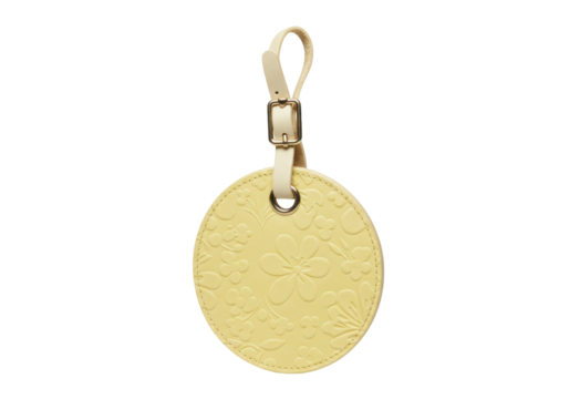 Pale yellow round luggage tag with floral pattern isolated, travel accessory for suitcase or bag identification
