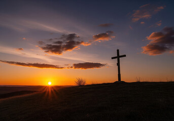 A profound wooden cross stands silhouetted against a radiant sunset on a hill, symbolizing hope and spiritual contemplation