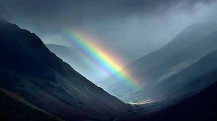 Stunning visual composition portrays a vibrant rainbow arcing across a dark, dramatic mountain landscape.