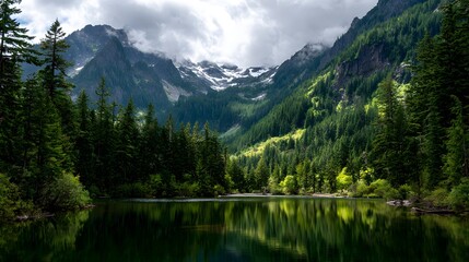 Fototapeta premium Majestic mountain range rises above a serene lake, lush evergreen forests cascade down the slopes reflecting in the calm water, under a cloudy sky, creating a tranquil and breathtaking wilderness...
