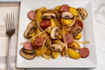 potatoe wedges  with kielbasa , onions and mushrooms