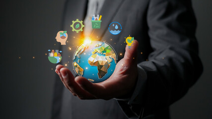ESG concept. Businessman holding a globe with icons for environmental, social, and governance. Sustainable business, corporate social responsibility (CSR), and clean energy for the future.