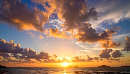 Obraz premium Dramatic sunrise with vivid colors over a calm sea. Wispy clouds are illuminated by golden hues