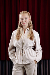 Portrait of a beautiful young female actress in a white suit.